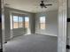 Spacious bedroom with carpet, large windows, and a ceiling fan at 1400 Equestrian Ct, Pahrump, NV 89048