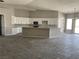 Open kitchen with island and white cabinets at 1400 Equestrian Ct, Pahrump, NV 89048