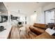 Open living area with brown leather sectional sofa and mid-century modern accents at 150 Las Vegas Blvd # 1909, Las Vegas, NV 89101