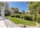 Expansive grassy backyard with stone pathway at 1613 Iron Ridge Dr, Las Vegas, NV 89117