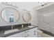 Modern bathroom with double sinks, shower, and tile floors at 1613 Iron Ridge Dr, Las Vegas, NV 89117