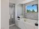 Elegant bathroom featuring a marble soaking tub at 1613 Iron Ridge Dr, Las Vegas, NV 89117