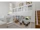 High-ceiling living room with chandelier and balcony at 1613 Iron Ridge Dr, Las Vegas, NV 89117