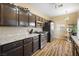 Modern kitchen with granite countertops and dark cabinetry at 1851 Hillpointe Rd # 2123, Henderson, NV 89074