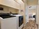 Convenient laundry room with washer, dryer, and extra shelving at 1851 Hillpointe Rd # 2123, Henderson, NV 89074