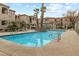 Community pool with surrounding patio and trees at 1851 Hillpointe Rd # 2123, Henderson, NV 89074