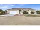 House exterior featuring a single-story home with a front yard and attached garage at 1920 Cavalry St, Pahrump, NV 89048