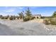 Landscaped yard and front view of house, with a gravel driveway at 1920 Cavalry St, Pahrump, NV 89048