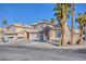 Two-story house with solar panels and palm trees at 2000 Golden Shadow Ct, Henderson, NV 89002