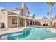 Inviting kidney-shaped pool with patio cover and seating at 2000 Golden Shadow Ct, Henderson, NV 89002