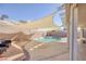 Relaxing pool area with shade sails and seating at 2000 Golden Shadow Ct, Henderson, NV 89002