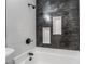 Modern bathroom with gray and white tile, shower, and built-in niches at 214 W Atlantic Ave, Henderson, NV 89015