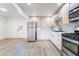 Modern kitchen with light wood cabinets, white countertops, and stainless steel appliances at 214 W Atlantic Ave, Henderson, NV 89015