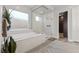 Luxurious bathroom featuring a soaking tub, walk-in shower, and spacious layout at 23 Via Tavolara, Henderson, NV 89011