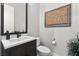 Stylish powder room with a modern sink and wood vanity at 23 Via Tavolara, Henderson, NV 89011