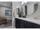 Modern bathroom with a large vanity mirror and dark wood cabinets at 23 Via Tavolara, Henderson, NV 89011