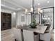 Modern dining room featuring a large square table and contemporary chandelier at 23 Via Tavolara, Henderson, NV 89011