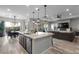 Modern kitchen island with granite countertops and stainless steel appliances at 23 Via Tavolara, Henderson, NV 89011