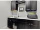 Laundry room with sink, granite countertop, and dark cabinets at 23 Via Tavolara, Henderson, NV 89011