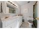 Bathroom featuring marble countertop vanity, neutral tile and modern fixtures at 2353 Moorpark Way, Henderson, NV 89014