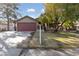 House exterior with a red garage door and mature trees at 2353 Moorpark Way, Henderson, NV 89014