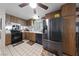 Functional kitchen featuring stainless steel refrigerator and wood cabinetry at 2353 Moorpark Way, Henderson, NV 89014