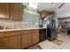 Kitchen featuring tile flooring, wooden cabinetry and stainless steel appliances at 2353 Moorpark Way, Henderson, NV 89014