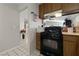 Kitchen with black appliances and wood cabinets at 2353 Moorpark Way, Henderson, NV 89014