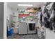 Laundry room with washer, dryer, and ample storage at 2353 Moorpark Way, Henderson, NV 89014