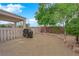 Spacious backyard featuring gravel, trees, brick wall, and a covered patio area at 2413 Cook Out Ct, Henderson, NV 89002