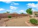 A well landscaped backyard featuring beautiful bushes and a dog play area at 2413 Cook Out Ct, Henderson, NV 89002