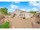 A spacious backyard with desert landscaping and a view of the house at 2413 Cook Out Ct, Henderson, NV 89002