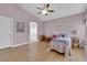 Bedroom boasts an archway entrance to the bathroom and light wood floors for a bright and airy feel at 2413 Cook Out Ct, Henderson, NV 89002