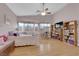 Bright bedroom featuring light wood floors, built-in bookshelves, and a cozy window seat with natural light at 2413 Cook Out Ct, Henderson, NV 89002