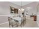 Inviting dining room featuring neutral walls, decorative chandelier, and views to additional living spaces at 2413 Cook Out Ct, Henderson, NV 89002