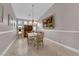 Bright dining room with a chandelier, neutral walls, tile flooring, and a view into other living spaces at 2413 Cook Out Ct, Henderson, NV 89002