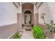 Inviting home exterior showcasing a beautiful front door and lush landscaping, adding to its curb appeal at 2413 Cook Out Ct, Henderson, NV 89002