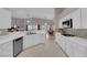 Bright, updated kitchen with white cabinets, countertops, stainless steel appliances, and decorative backsplash at 2413 Cook Out Ct, Henderson, NV 89002