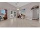 Living room with tiled floor, large windows, vaulted ceiling and access to the backyard at 2413 Cook Out Ct, Henderson, NV 89002