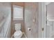 Powder room showcases a toilet, and a small window, plus it conveniently connects to the walk-in tub area at 2413 Cook Out Ct, Henderson, NV 89002