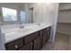 Double vanity bathroom with dark wood cabinets and quartz countertop at 242 Botanic Gardens Dr, Las Vegas, NV 89148