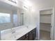 Double vanity bathroom with large mirror and walk-in closet at 242 Botanic Gardens Dr, Las Vegas, NV 89148