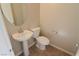 Small half bathroom with pedestal sink and toilet at 242 Botanic Gardens Dr, Las Vegas, NV 89148