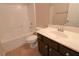 Bathroom with tub, toilet and dark brown vanity at 242 Botanic Gardens Dr, Las Vegas, NV 89148