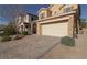 Front view of the house with a brick paved driveway and landscaping at 242 Botanic Gardens Dr, Las Vegas, NV 89148