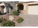 Landscaped front yard with a brick walkway and large rock accents at 242 Botanic Gardens Dr, Las Vegas, NV 89148