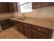 Kitchen boasts granite countertops and dark wood cabinets at 242 Botanic Gardens Dr, Las Vegas, NV 89148