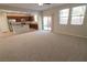 Spacious living room with carpet flooring and access to backyard at 242 Botanic Gardens Dr, Las Vegas, NV 89148