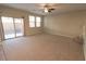 Bright living room featuring carpet and sliding glass door at 242 Botanic Gardens Dr, Las Vegas, NV 89148