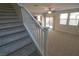 Carpeted staircase with white railings at 242 Botanic Gardens Dr, Las Vegas, NV 89148